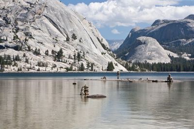 Scenic view of lake by mountains against sky