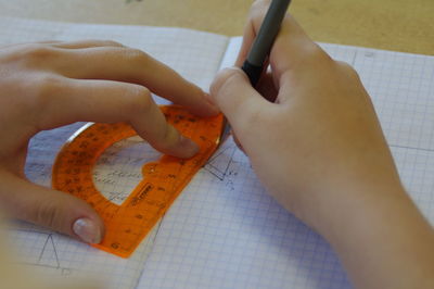 Close-up of human hand holding paper