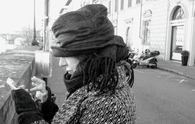 Portrait of senior woman on street in city during winter