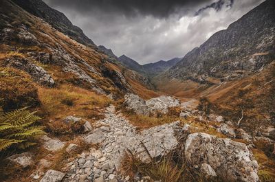 Scenic view of mountains against cloudy sky