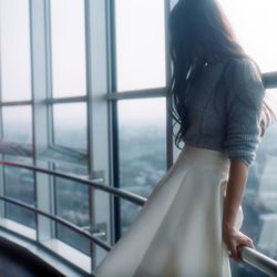 Close-up of woman standing on railing