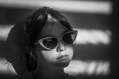 Close-up of young woman wearing sunglasses