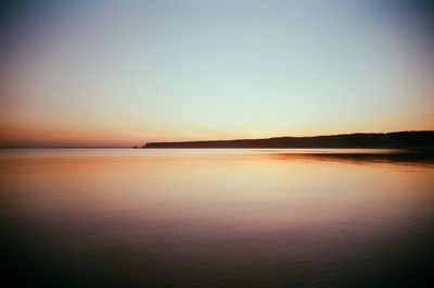 Scenic view of sea against clear sky during sunset