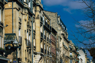 Low angle view of buildings against blue sky