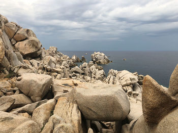 View of rocks on beach against sky