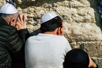 Rear view of man standing on rock