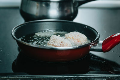 Close-up of meat in cooking pan on table