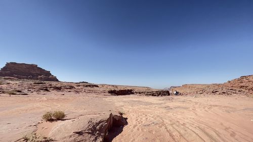 Rock formations in desert against clear blue sky