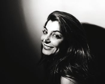 Close-up portrait of smiling young woman