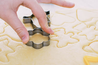 Girl bakes christmas cookies, cooking in the kitchen.