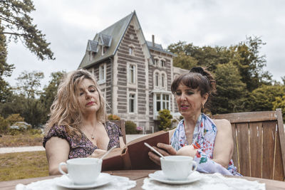 Portrait of smiling friends sitting in cafe