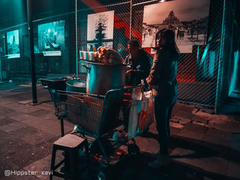 Side view of people standing at store