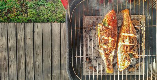 High angle view of meat on barbecue grill