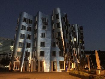 Low angle view of illuminated building at night