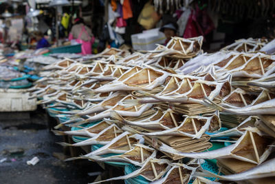 Stack of firewood for sale at market stall