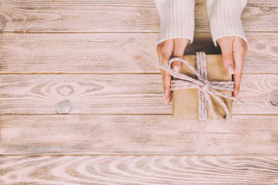 Low section of woman standing on wooden floor