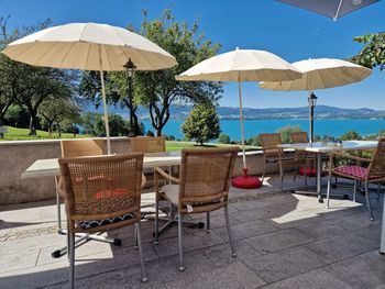 Empty chairs and tables in yard