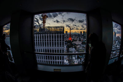 Silhouette people seen through glass window