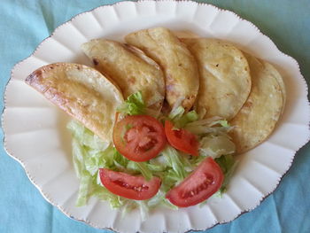 Close-up of chicken tacos with salad in plate