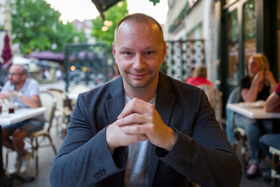 Portrait of young man sitting outdoors