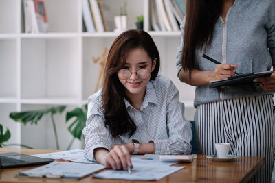 Businesswoman working with colleague at office