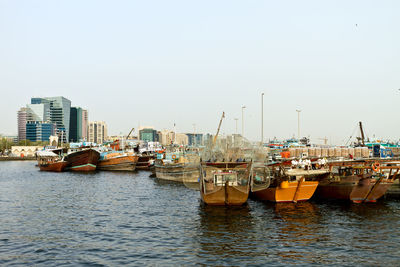 Sailboats moored in harbor