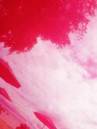 Low angle view of pink umbrella against sky