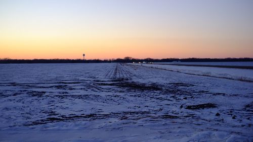 Scenic view of landscape against clear sky during sunset