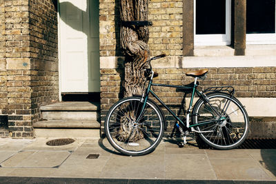 Bicycle leaning against wall of house