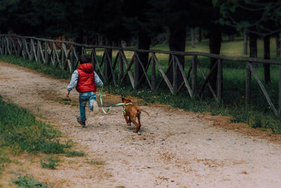 Child with dog running