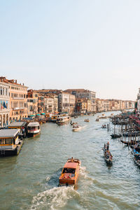 Boats and gondolas navigating through grand canal in venice, italy.