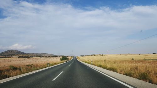 Road amidst landscape against sky