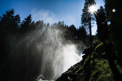 Low angle view of waterfall against sky