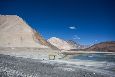 Scenic view of desert against blue sky