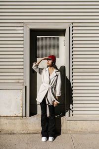 Elegant woman shielding eyes on sunny day