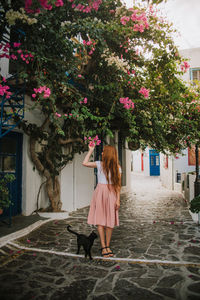 Girl standing by flowering tree