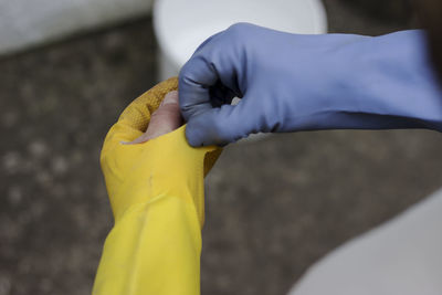 Midsection of person working with yellow umbrella