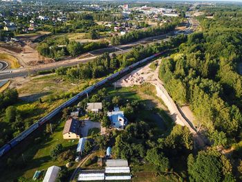 High angle view of road amidst trees and buildings in city