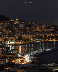 High angle view of illuminated buildings in city at night