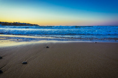 Scenic view of beach against sky during sunset