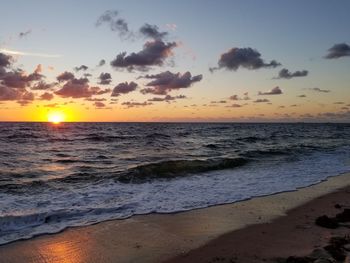 Scenic view of beach against sky during sunset