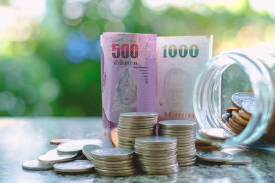 Close-up of money and jar on table