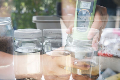 Close-up of hand holding glass jar