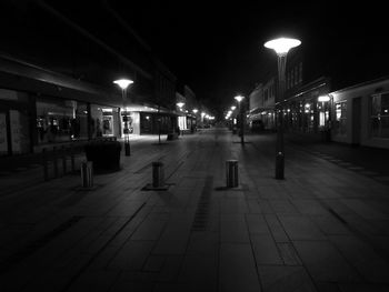 Illuminated railroad station platform at night