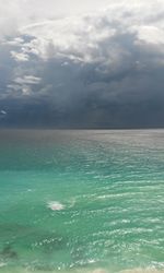 Scenic view of sea against storm clouds