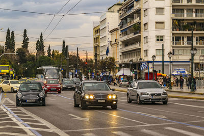 Traffic on road in city against sky