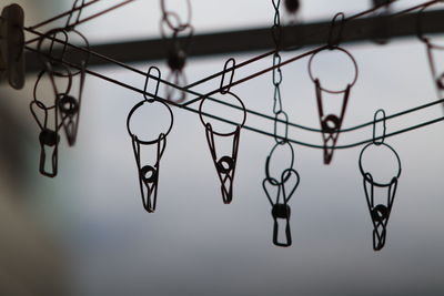 Low angle view of clothespins hanging on clothesline