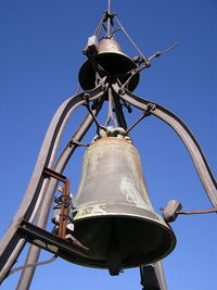 Low angle view of bell tower against clear blue sky