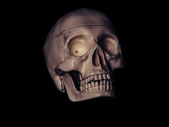 Close-up of mannequin against black background