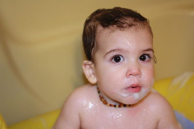Close-up portrait of baby boy taking bath